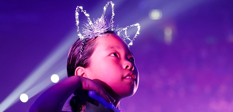 SWSpurple young students performing at School Spectacular with purlpe background
